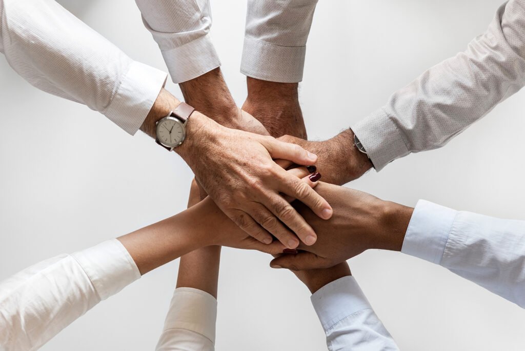 Mains réunies illustrant la confiance, l’engagement et la relation d’accompagnement